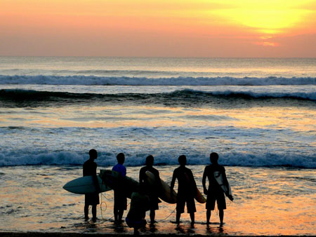 Surfers at sunset