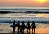 Surfers at sunset